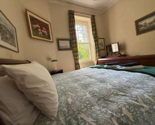 Double bedroom with garden and woodland view